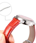 Close-up of a watch with a red leather strap showing installed 19mm Curved Spring Bar Pins 1.5mm Diameter Stainless Steel Double Flanged End.