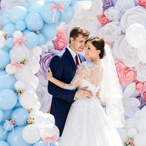 Elegant wedding with Arch Clip Kit For Balloons, white and blue balloon garland, floral backdrop, bride and groom embracing.