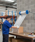 Zero Fuss Wall Mount Bubble Wrap Dispenser With Heavy Duty Foam Roll Packer Runs Super Slick For Active Packing Stations Includes Full Hardware Kit Fits One Meter Wide Films For Swift Daily Shipments in a warehouse setting.
