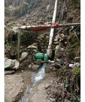 1000W Hydroelectric Water Turbine Generator 220V Off Grid Power System installed in a stream with visible copper coil housing