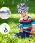 Child using magnifying glass from Kids Camping Set With Pop Up Tent And Outdoor Gear For Pretend Play Adventures.