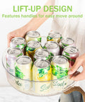 Person holding Round 12 Inch Lazy Susan Organizer With Non Skid Liners And Handle, filled with soda cans, showing lift-up design.