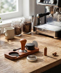 Pro Game Changer 7 Piece Espresso Essentials Featuring 53 Mm Tamper Wdt Tool Coffee Distributor and Sapele handle on a wooden countertop.