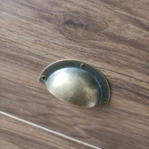 Top Shelf Vintage Shell Cup Pulls For Kitchen Cabinets And Dresser Drawers Bronze Iron Handles With Screws Smooth Finish Durable Home Decor Hardware Installation Kits mounted on wooden surface.