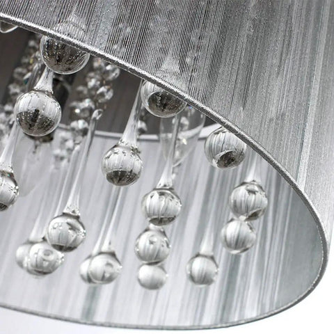 Close-up of raindrop crystal drum chandelier with fabric shade, highlighting K9 crystal details and sparkling accents.