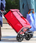 Red trolley cart equipped with 2 Pack Heavy Duty Shopping Cart Wheels Replacement For Trolley Carts Compact Lightweight Casters with Stair Climbing Design.