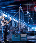 Worker using Lever Chain Hoist 3300 Lbs Capacity, 20 Ft Lift, One And A Half Ton Manual Ratchet Chain Puller in industrial setting