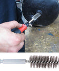Hand using Stainless Steel Bore Brush Set Two Pack with Three Quarter Inch Hex Shank Twisted Round Wire Brushes for drill cleaning.