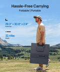 Man carrying Portable Solar Generator Kit With 350W Panel, 1440Wh Power Station, 1800W Continuous Output, folded, outdoors.