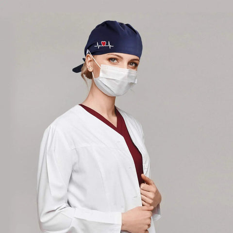 Model wearing navy scrub cap from 12 Pack Bouffant Scrub Caps Unisex Adjustable Button Hats With Sweatbands Gourd Shaped Nursing Surgical Cap