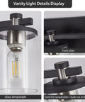 Close-up of Three Light Matte Black And Brushed Nickel Bathroom Vanity Light Fixture showing glass lampshade and E26 base.