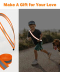 Boy walking dog with See And Be Seen High Visibility Reflective Tape Strip 2 Inch By 66 Foot Sew On Orange for safety.