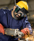 Job Site Tough Flip Up Welding Safety Glasses With Vented Anti Fog Shell Double Layer Shatterproof Lenses For Stick Mig Argon Cuts And Everyday Shop Grinds 2 Pack worn by a worker using a grinder.