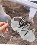 Durable Lawn Aerator Shoes with metal spikes shown on soil with hand holding a spike, perfect for easy grass and lawn care.