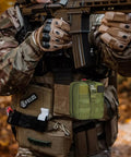 Emergency First Aid Kit IFAK With MOLLE Admin Pouch attached to soldier gear for outdoor adventures