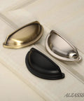 Brushed satin nickel, black, and brass cabinet cup pulls on a white surface, 3 inch hole centers 76mm for cabinets and drawers.
