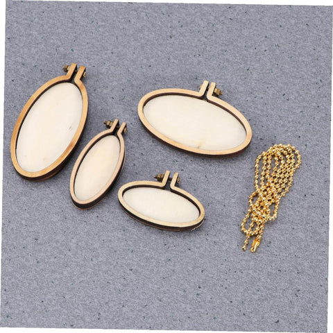 Five Piece Mini Wood Embroidery Hoops Set With Screws For Cross Stitch And DIY Needlework displayed on fabric surface