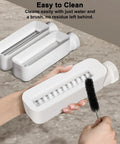 Electric Pasta Maker With Roller And Cutters For Fresh Noodles showing a user cleaning the machine with a brush for easy maintenance.