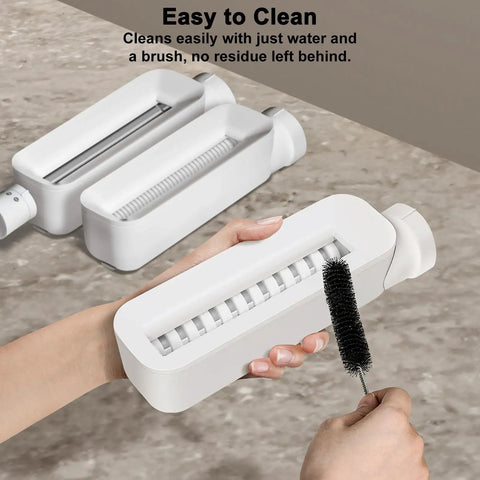 Electric Pasta Maker With Roller And Cutters For Fresh Noodles showing a user cleaning the machine with a brush for easy maintenance.