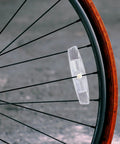 Six Piece Bicycle Spoke Reflectors White Safety Wheel Reflectors Set attached to bike wheel