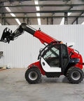 Versatile Telescopic Handler With Quick Attach System And Enclosed Brake For Warehouses Farms Or Industrial Job Sites shown in side view with raised boom.