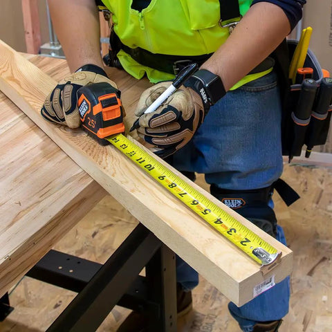 Heavy Duty Pro-Grade 16-Foot Tape Measure With Single Hook Nylon Reinforced Blade And Metal Belt Clip in use on wood