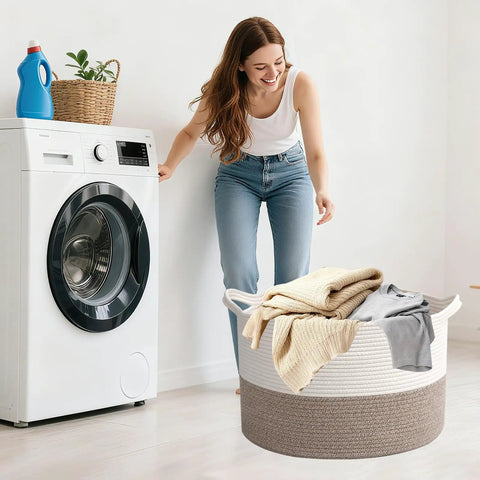 Woman using 65L Large Woven Cotton Rope Laundry Basket With Reinforced Handles No Snag Edges Rugged Hamper in laundry room