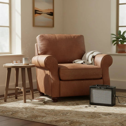 MD 20 Mini Deluxe Guitar Amp Bundle With Power Supply placed beside brown armchair and table in cozy living room.