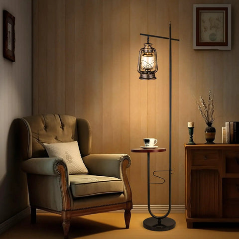 Vintage Floor Lamp With Built-In Table And Arc Lantern In Rustic Bronze Gold Finish beside armchair in cozy living room corner.