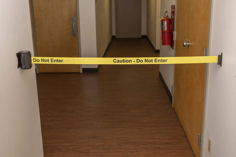 Wall Mount Safety Barrier With Retractable Belt 13 Foot Caution Belt Easy Install Braking System And Lock Button To Prevent Belt Release Keeps Traffic Out Space Saving Industrial Grade Crowd Control Gate During Cleanups installed in hallway.