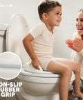 Toddler Potty Training Seat With Sure Grip Handles And Non Slip Base For An Easy Peasy Transition To The Big Toilet Includes Splash Guard Plus Handy Wall Hook Gray, child sitting on toilet.