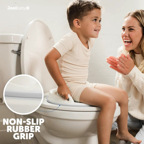 Toddler Potty Training Seat With Sure Grip Handles And Non Slip Base For An Easy Peasy Transition To The Big Toilet Includes Splash Guard Plus Handy Wall Hook Gray, child sitting on toilet.