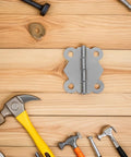 24Pcs Vintage Butterfly Hinges Set With Replacement Screws for DIY Home Decor shown on wooden surface with assorted tools.