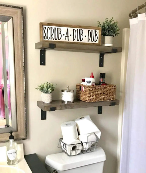 Bathroom scene with floating shelves mounted using Built Tough 5.5 Inch Black Shelf Brackets With Lip For Floating Shelves, 6 pack.