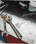 Built Like A Tank Stainless Steel Sliding Door Hanger With Double Bearing Track Rollers placed on a metal workbench with tools.