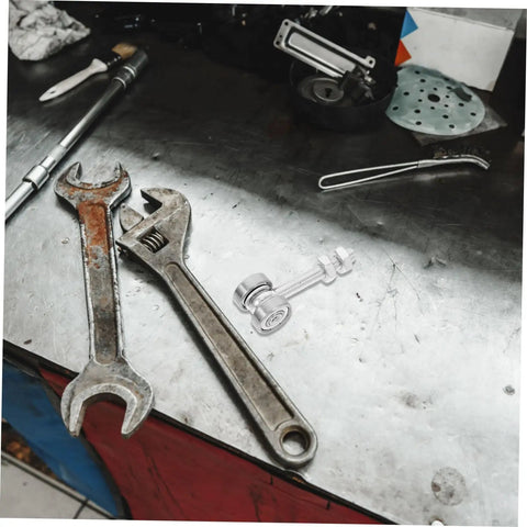 Built Like A Tank Stainless Steel Sliding Door Hanger With Double Bearing Track Rollers placed on a metal workbench with tools.