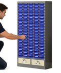 Heavy Duty 52 Drawer Parts Cabinet With Tough As Nails Steel Construction And Secure Door Lock, displaying a man organizing tools.