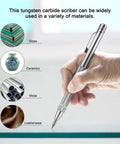 Hand holding 4 Pack Tungsten Carbide Scriber Tool Set With Magnet, Pro Grade Metal Engraving Pen on glass surface