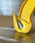 Disposable Film Cutter With Sharp Steel Blade And Safe Hidden Blade Design for Easy Cutting on tape, yellow handle close-up
