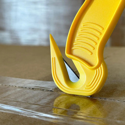 Disposable Film Cutter With Sharp Steel Blade And Safe Hidden Blade Design for Easy Cutting on tape, yellow handle close-up