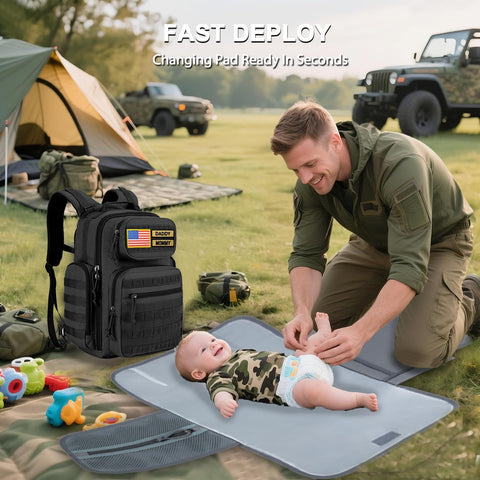 Active dad using Military Style Diaper Backpack With Large Changing Pad And Insulated Compartments For Active Dads On The Go With Dad Gear For Hiking Travel Camping Army Inspired Tan at campsite