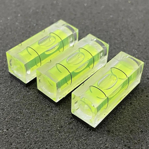 Three sleek acrylic six pack mini magnetic bubble levels with neon vials for precise measurements.