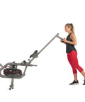 Person folding Phantom Hydro Water Rowing Machine With Realistic Water Resistance 60 Degree Tank 16 Hydro Blades Silver Finish SF RW5910