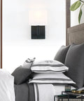 Black Finish Wall Sconce With White Textile Shade, On Off Switch, Sleek Modern Nightstand Lamp For Bedroom And Bedside Reading, E26 Base Compatible, Dimmable With Compatible Bulbs, Bulbs Not Included in bedroom setting.