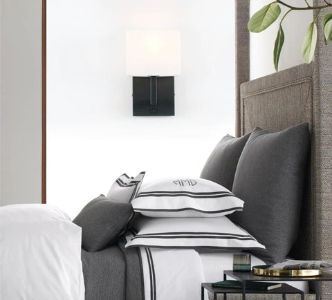 Black Finish Wall Sconce With White Textile Shade, On Off Switch, Sleek Modern Nightstand Lamp For Bedroom And Bedside Reading, E26 Base Compatible, Dimmable With Compatible Bulbs, Bulbs Not Included in bedroom setting.