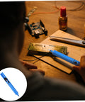 Person using Desoldering Gun Solder Sucker Pen Set 2 Pack Vacuum Solder Removal Tool For PCBs on circuit board at workbench