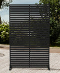 Front view of Six Panel Outdoor Privacy Screen Set With Freestanding HDPE Panels And Stand on patio, surrounded by plants.