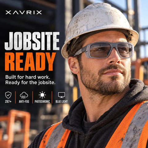 Smooth Transition Z87 Safety Glasses With Hella Clear Photochromic Lenses Anti Fog UV400 Blue Light Blocking For Driving And Work Top Shelf Eye Protection In Slick Gray worn by a man in a hard hat, looking confidently outdoors.
