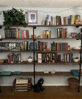Industrial Style Pipe Shelf Brackets Set Dope Three Pcs Five Tier Wall And Ceiling Shelves Hardware Only For DIY Open Bookshelves Rustic Farmhouse Look 70 Inches Tall 12 Inches Deep with books and decor.