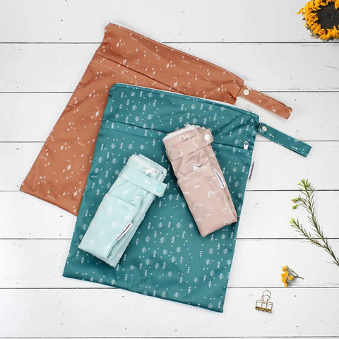 Two Pack Wet Dry Bags On The Go For Travel Pool Beach Gym And Baby Gear, Waterproof Polyester Diaper Bags with prints on wood surface